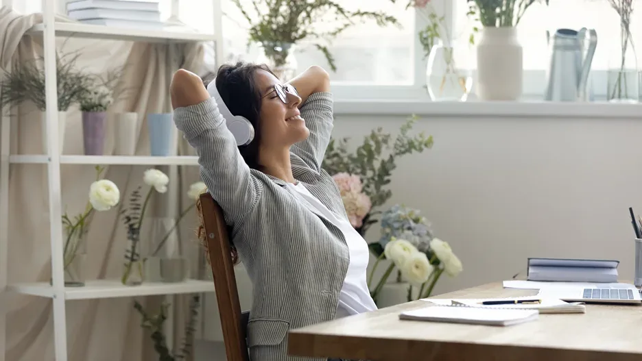 a portrait of a happy woman listening to music