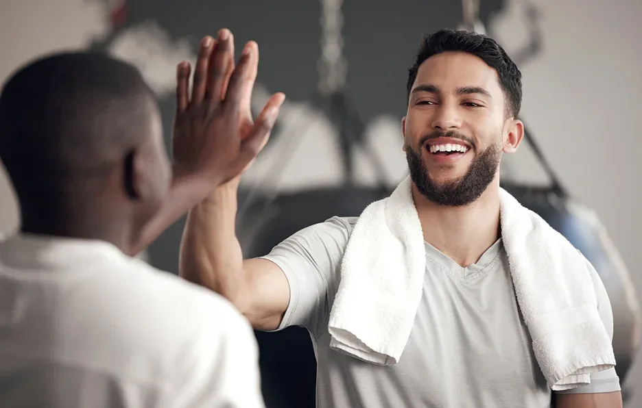 two males exercising in the gym