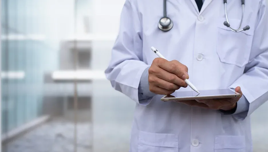 a doctor holding a digital tablet doing his research