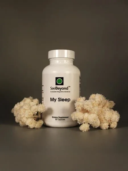 SeeBeyond My Sleep dietary supplement bottle beside dried white flowers