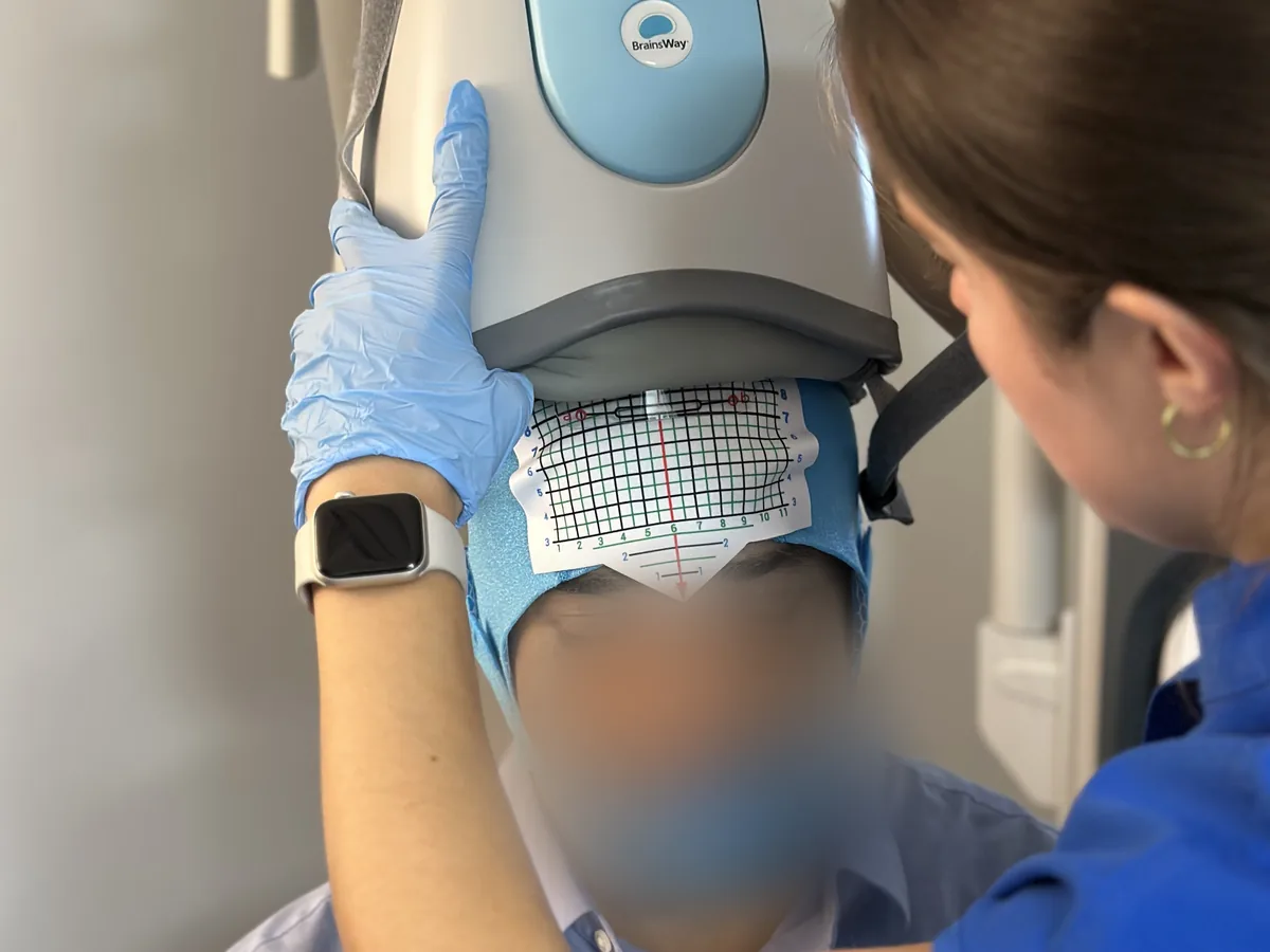 Deep TMS brain health — patient being fitted for a BrainsWay Deep TMS session at SeeBeyond Medicine