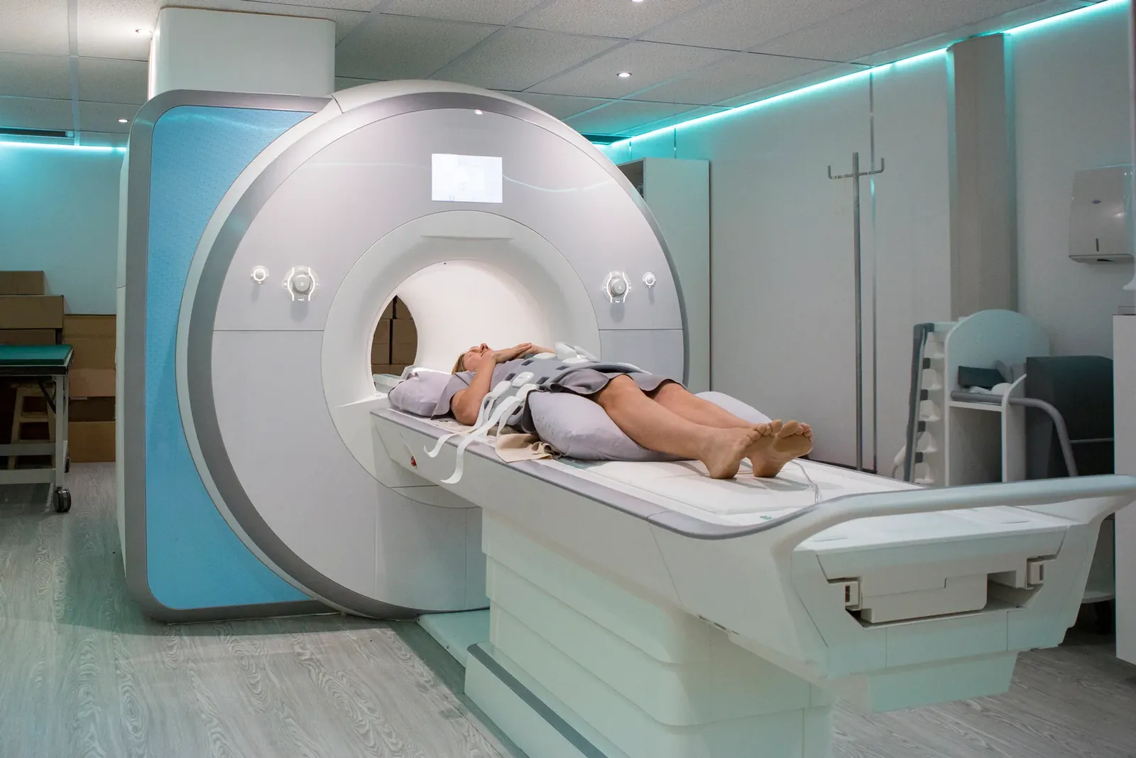 Patient lying on the table of an MRI scanner in a modern imaging room