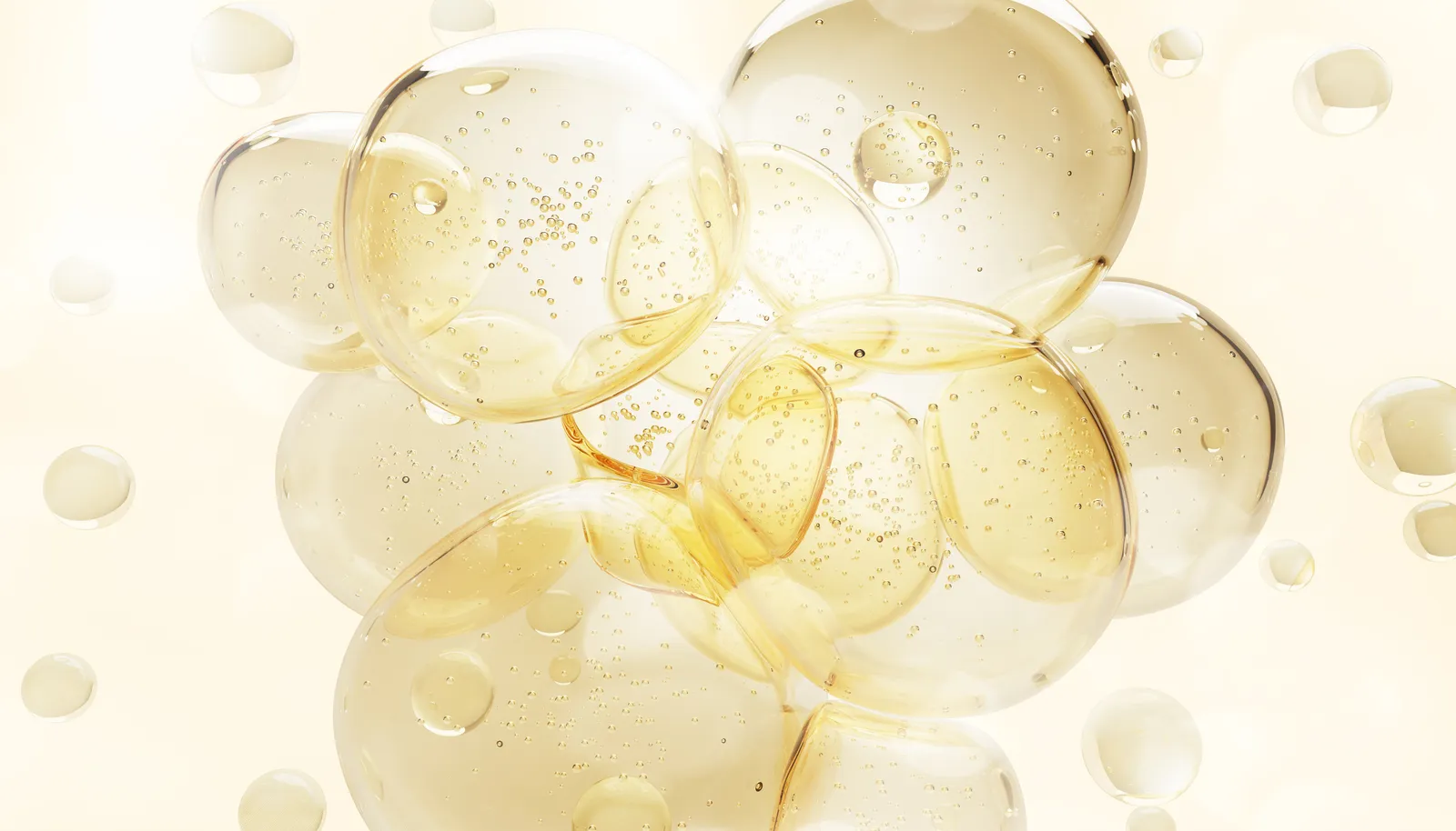 Cluster of translucent golden bubbles on a pale cream background
